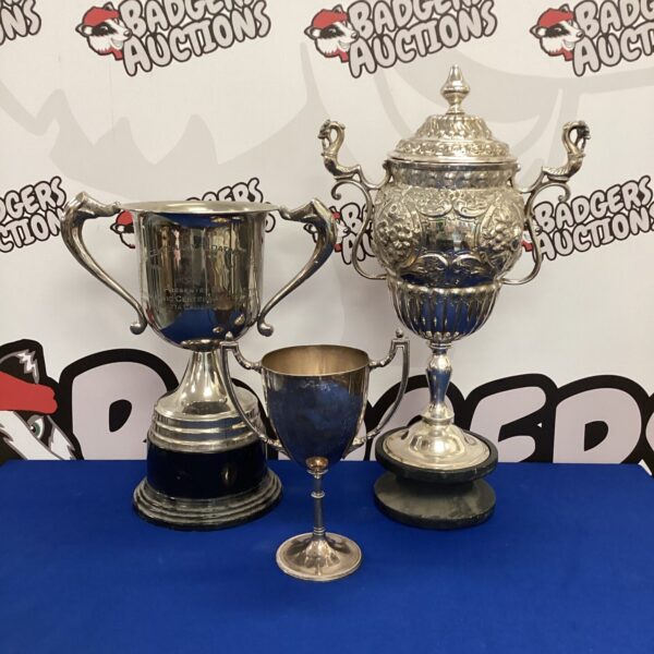 Antique silver plate trophies with engraved details.