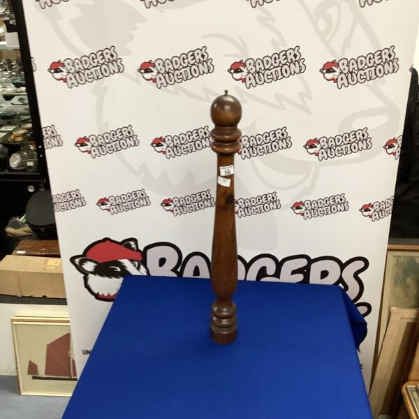 Tall vintage wooden pepper mill for kitchen use.