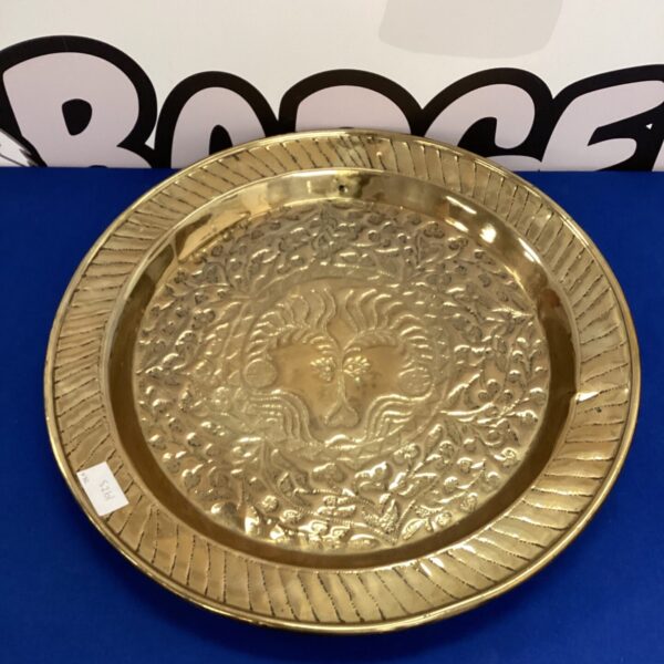Intricate detail on a large vintage brass charger plate.