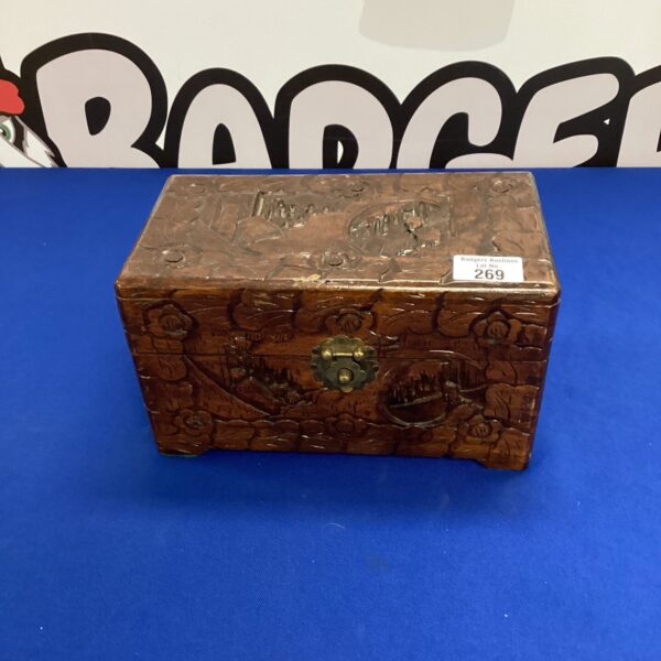Intricately carved dark wood jewellery box with floral details.
