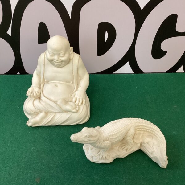 Resin Buddha and crocodile ornaments for home decor.