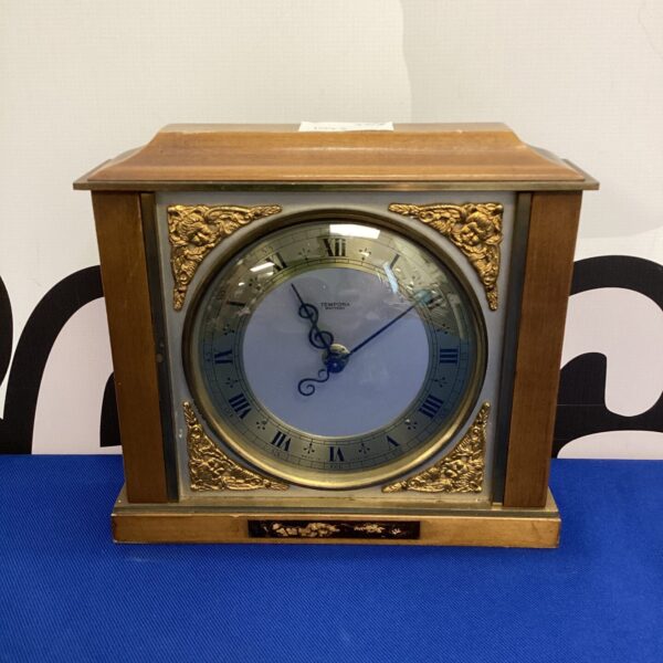 Vintage Tempora mantle clock with white dial and wooden case.