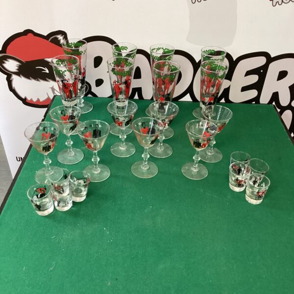 Lot of vintage printed drinking glasses with colourful designs.