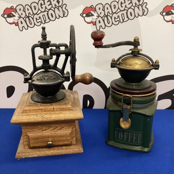 Antique coffee grinder mills with wooden bases and cast iron mechanisms.