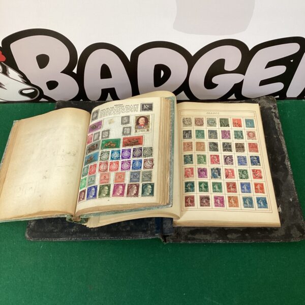 Open vintage stamp album displaying European stamps.