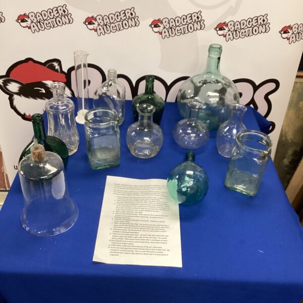 Vintage glass bottles and flasks in a collector's lot.