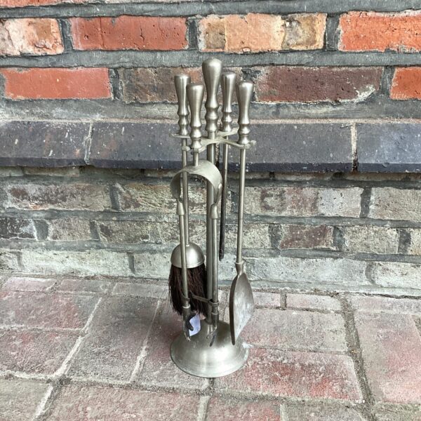 Stainless steel fireplace companion set with five tools.