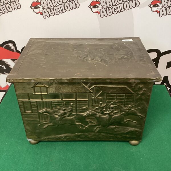 Detailed vintage brass log box with hunt scene embossing.