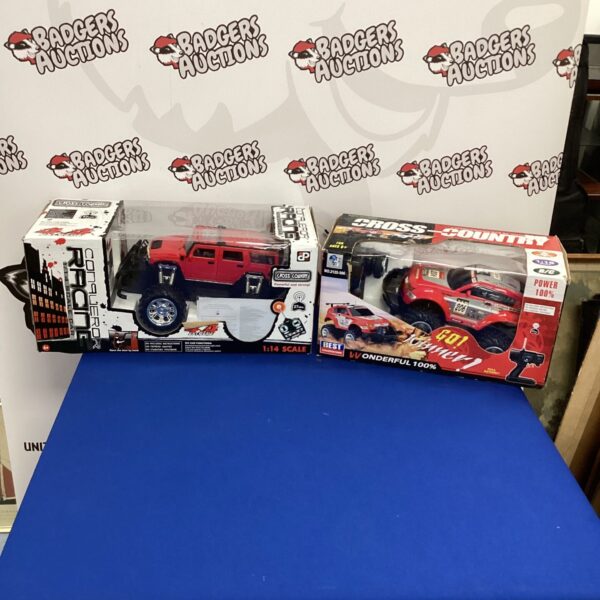 Two remote control cars in original boxes, ready for restoration.