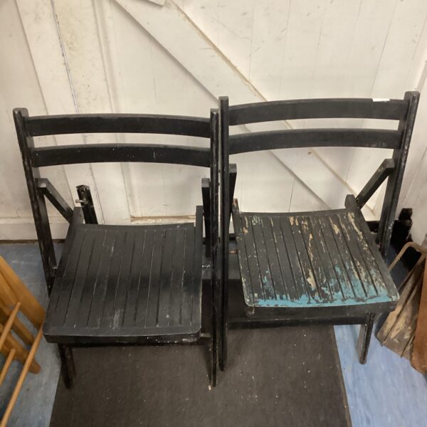 Pair of vintage black folding garden chairs for outdoor use.