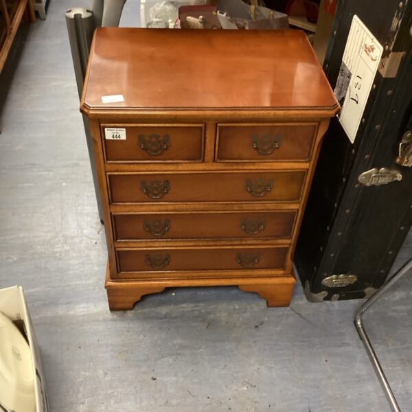 Antique walnut two over three cabinet with decorative pulls.