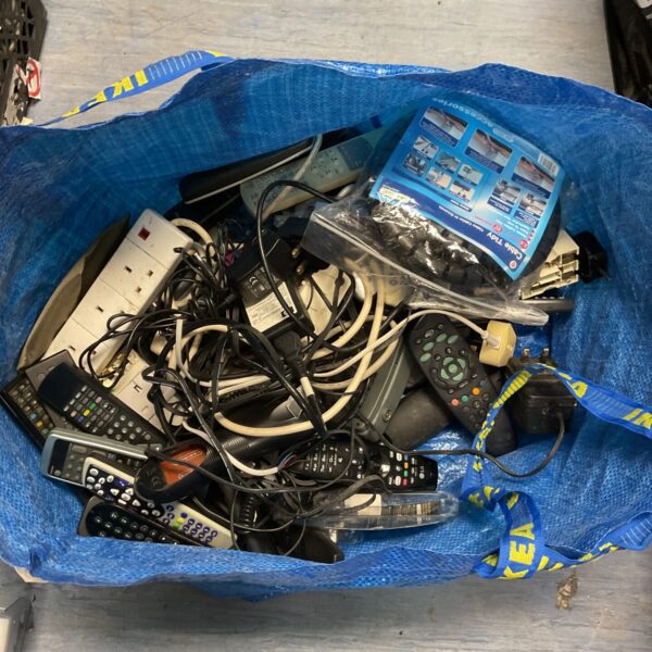 Mixed lot of cables and remotes for electronics and TV.