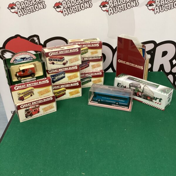 Vintage diecast buses with booklets, a collectible transport lot.