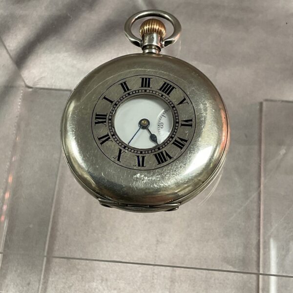 Antique silver half hunter pocket watch with Roman numerals.