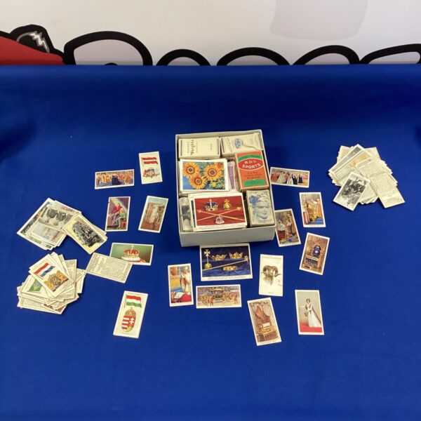 Vintage cigarette card collection with various subjects and designs.