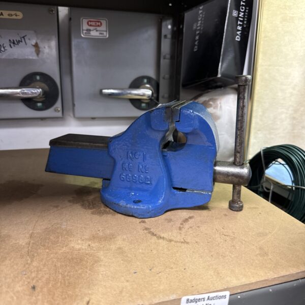 Small metal bench vice for workshop use.
