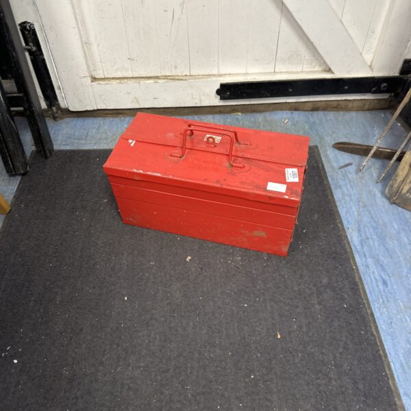 Vintage red metal cantilever toolbox with contents.