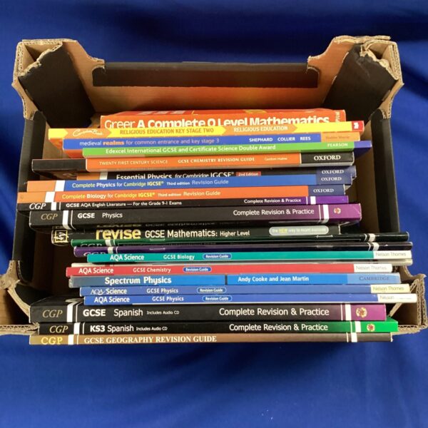 Collection of GCSE revision books for exam preparation.