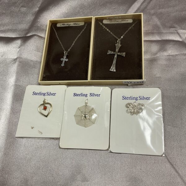 Vintage silver pendant necklaces and crucifixes in a lot.