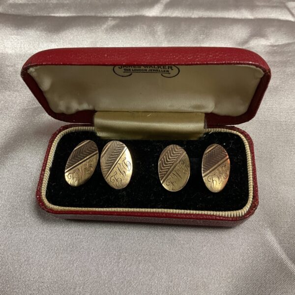 Pair of vintage 9ct gold cufflinks on a display card.