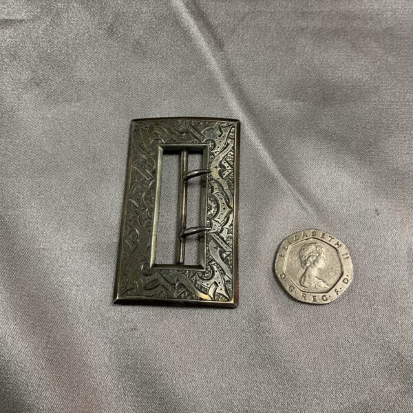 Intricate silver belt buckle with floral engraving, hallmarked 1878.