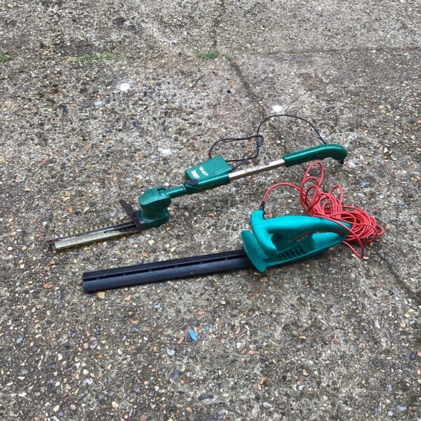 Bosch electric hedge trimmer with copper blade for garden maintenance.