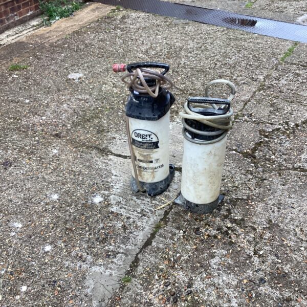 Vintage handheld water pressure tank for garden use.