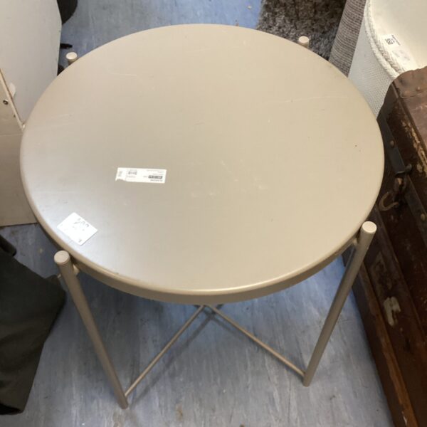 Round metal Ikea coffee table with minimalist design.