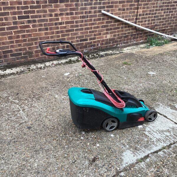 Bosch electric lawn mower in a garden setting.