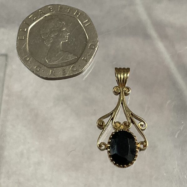 Vintage 9ct gold pendant with a central sapphire gemstone.