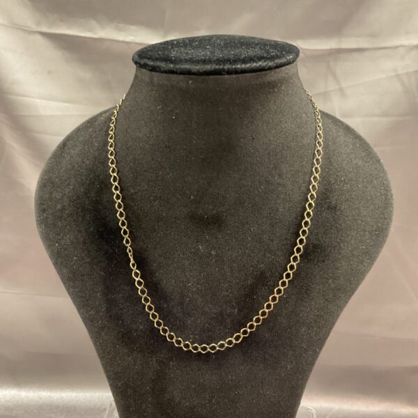 Close-up of a delicate 9ct gold necklace chain.