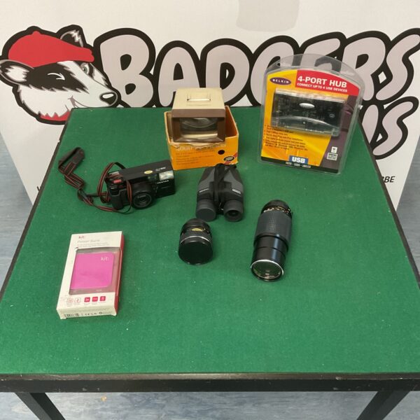 Vintage camera lot with Pentax camera, binoculars, and lenses.