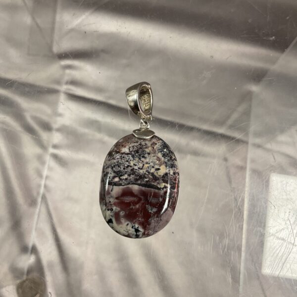 Silver pendant with red and white agate gemstone.