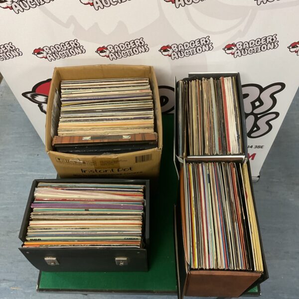 Large box filled with a diverse vinyl record collection.