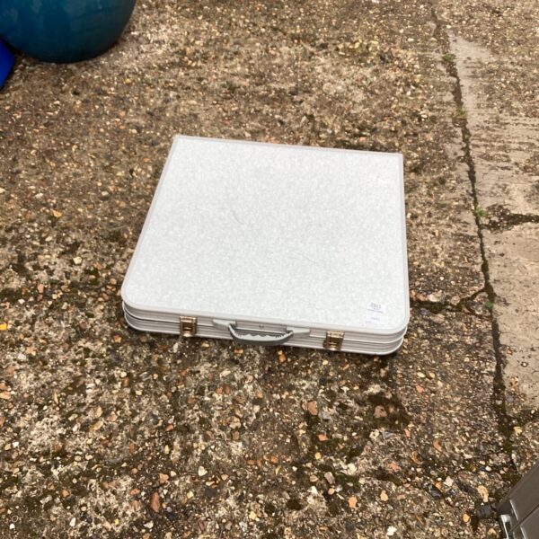 Portable folding camping table set up outdoors.