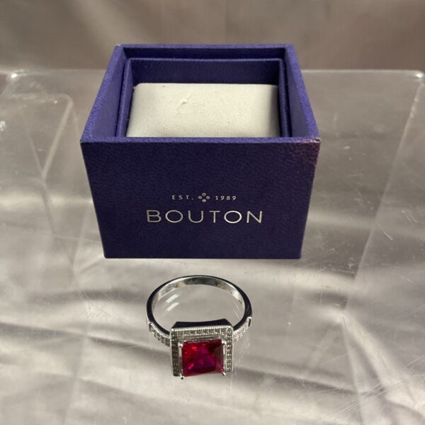 Silver ring with a vibrant red stone, size U.
