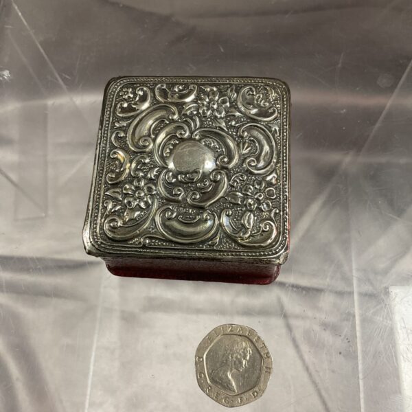 Antique silver trinket pot with floral embossed design.
