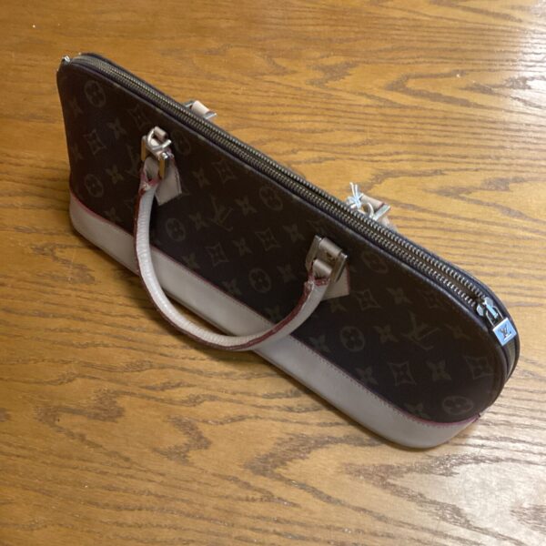 Tan and brown Louis Vuitton style handbag with a monogram pattern.