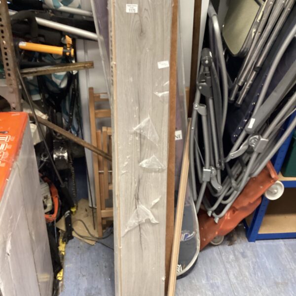 Two packs of unopened grey laminate flooring for home renovation.