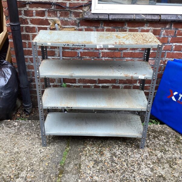 Vintage metal shelving unit in a shed setting.