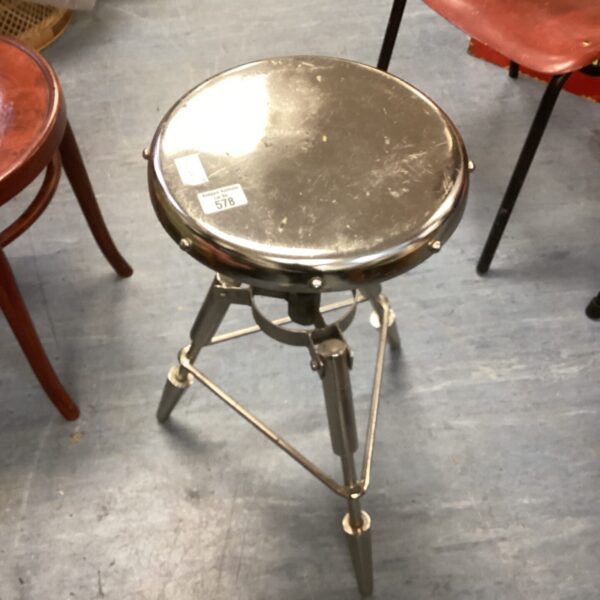 Vintage chrome swivel stool with adjustable height and circular seat.