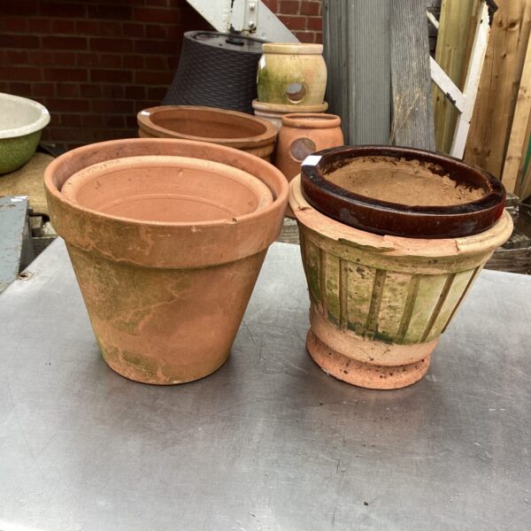 Lot of four vintage terracotta garden planters for outdoor use.