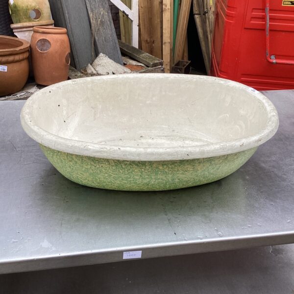 Weathered vintage metal garden basin, repurposed bath planter.