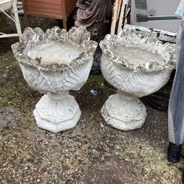 Pair of weathered stone effect garden planters for outdoor display.