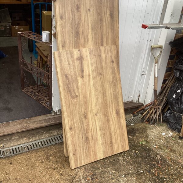 Two sections of wood effect laminate worktop for kitchen use.