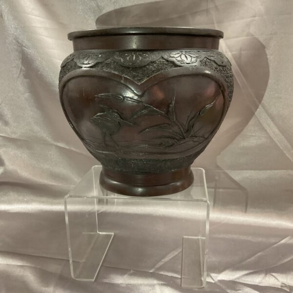 Antique Japanese bronze vase with bird and floral carvings.