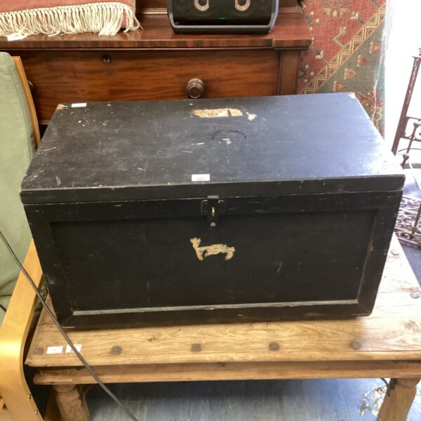 Dark wooden vintage travel trunk with metal accents.