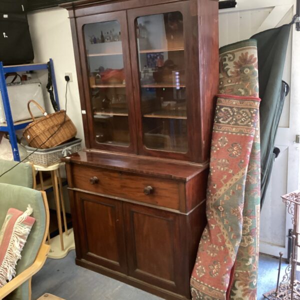 Vintage dark wood display cabinet with glass doors.