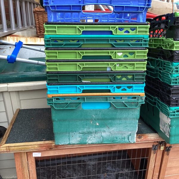 Lot of eight plastic storage crates for garden or household use.