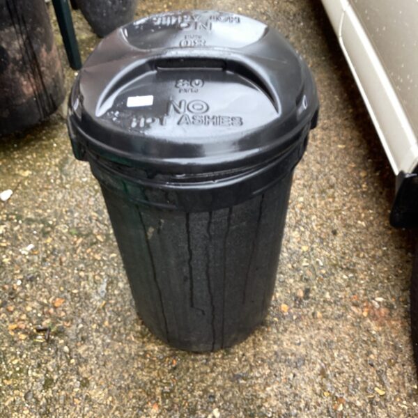Dark plastic garden waste bin outdoors.